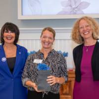 Amanda smiling with president and provost